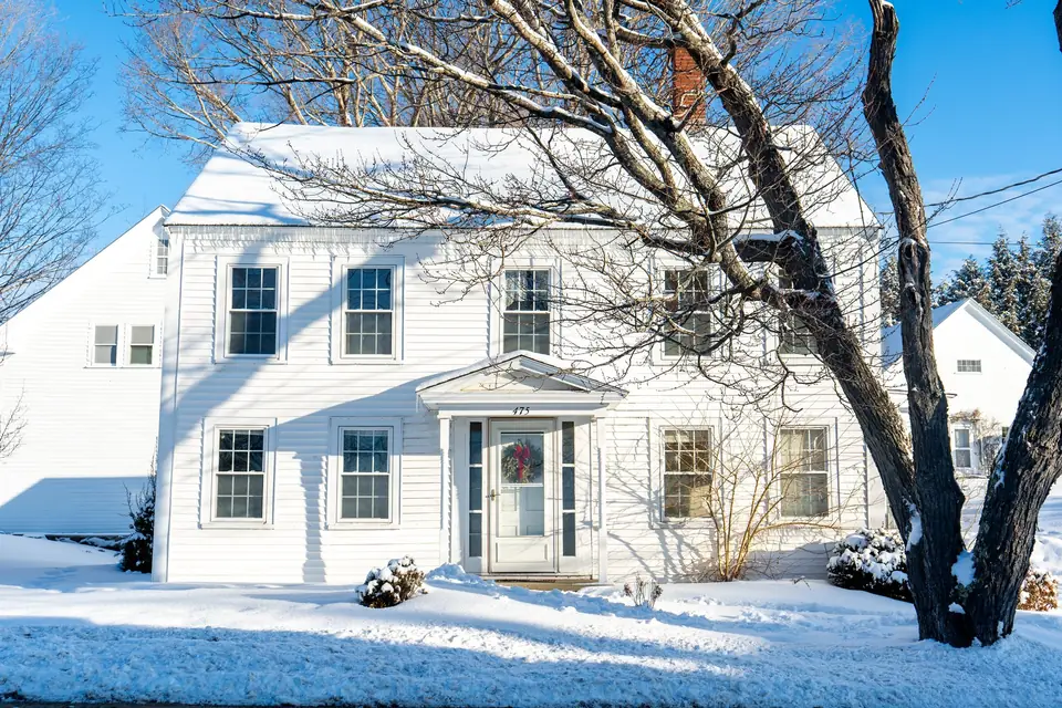 White colonial house after a fresh snowfall